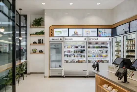 Pressed Juicery store with Samsung QMC 43-inch menu boards in a row above the counter, installed by CrownTV